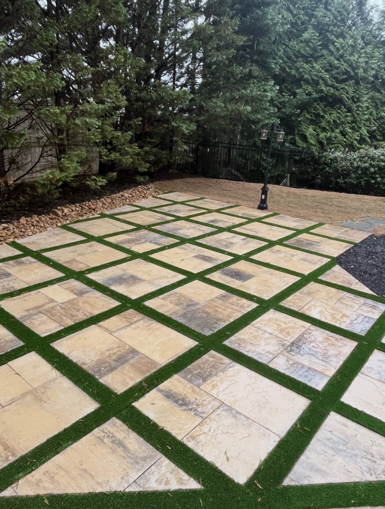 Paver and turf ribbon patio with landscape lighting